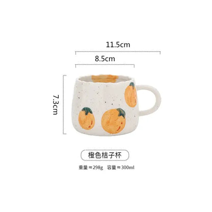 A white ceramic hand-painted cartoon fruit mug with orange citrus designs and curved handle for kitchen tea decorbites cartoon fruit