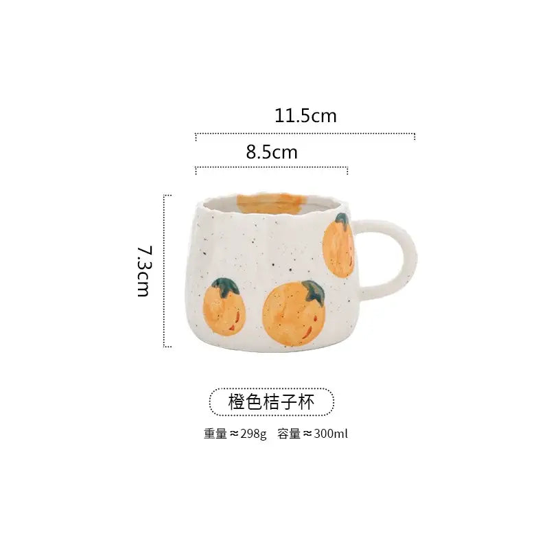 A white ceramic hand-painted cartoon fruit mug with orange citrus designs and curved handle for kitchen tea decorbites cartoon fruit