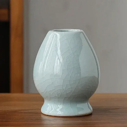 Delicate celadon ceramic pear-shaped whisk holder stand with subtle crackle glaze for matcha whisk display and storage