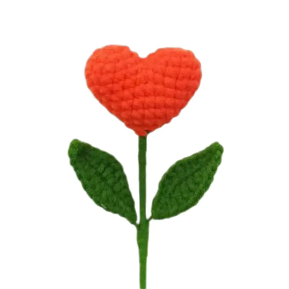 A hand woven love yarn crochet orange heart shaped flower with green leaves for bedroom decor bouquet