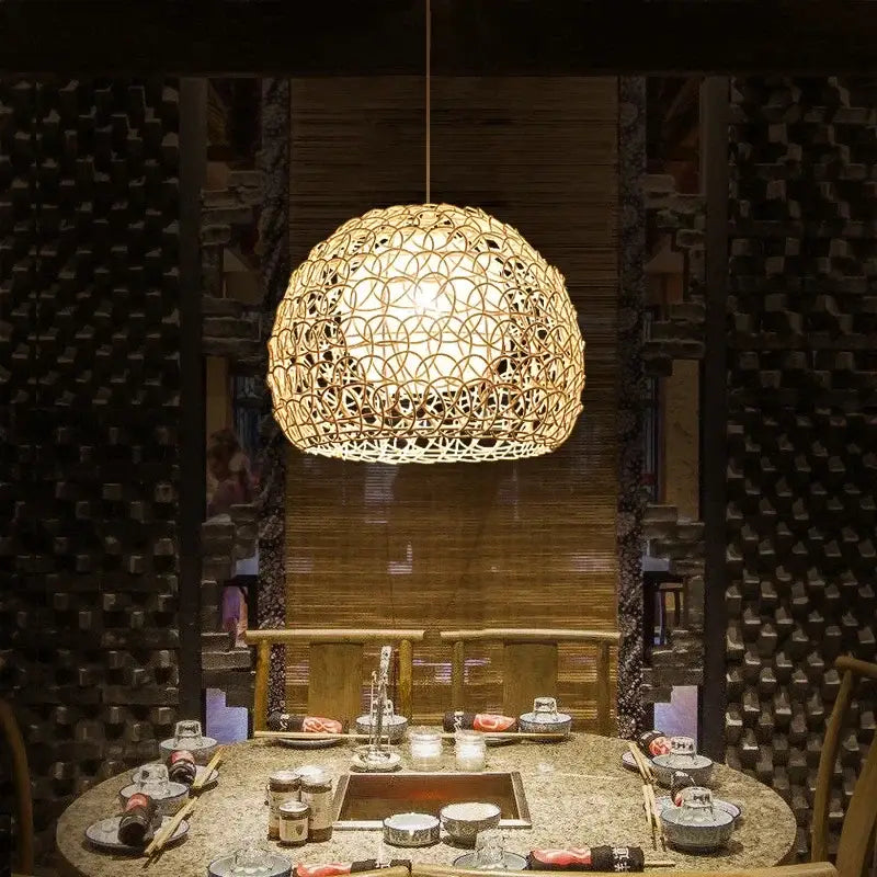A warm spherical hand woven rattan pendant light in natural bamboo with intricate lattice for modern living rooms