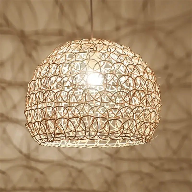 A warm-toned spherical hand woven rattan pendant light with intricate circular pattern for modern living room chandelier