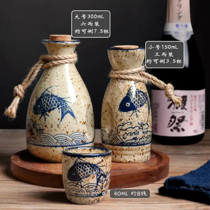 Handcrafted cream ceramic wine set with blue fish wave patterns speckled glaze and twine ties for dining room use