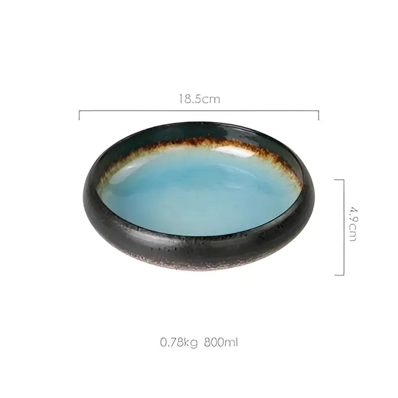 A sleek oval ceramic sushi plate with glossy turquoise interior and dark speckled exterior rim for dining use