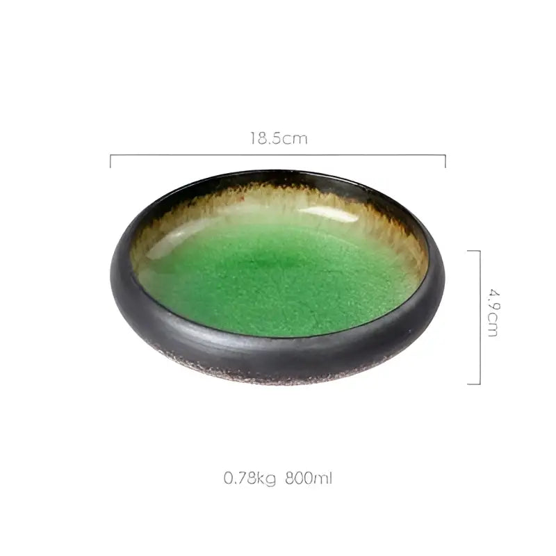 Handcrafted ceramic sushi plate with glossy black rim, vibrant green interior, and subtle gold speckles for elegant dining