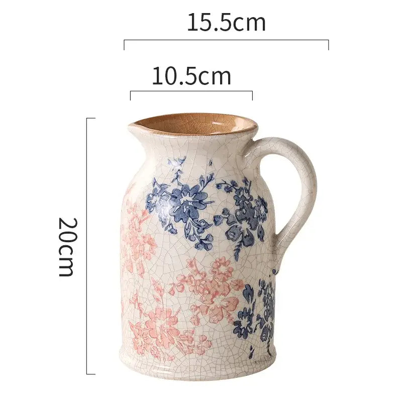 A crackled white ceramic vase with blue and pink floral patterns and brown handle from decorbites blue living room decor