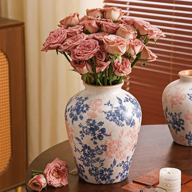 Handcrafted white ceramic vase with crackled blue and pink floral design holding soft pink roses for living room decorbites decor