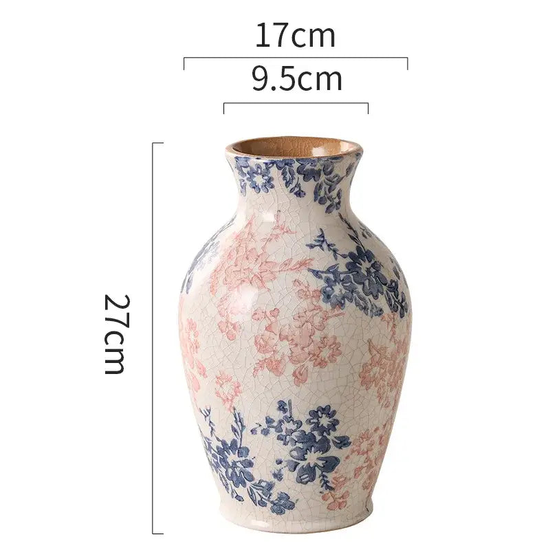 A tall crackled white ceramic vase with delicate pink and blue floral patterns for decorbites blue living room decor