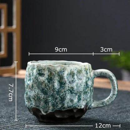 Handcrafted ceramic mug set featuring a green and white speckled glaze with scalloped rim and hammer pattern ceramic design