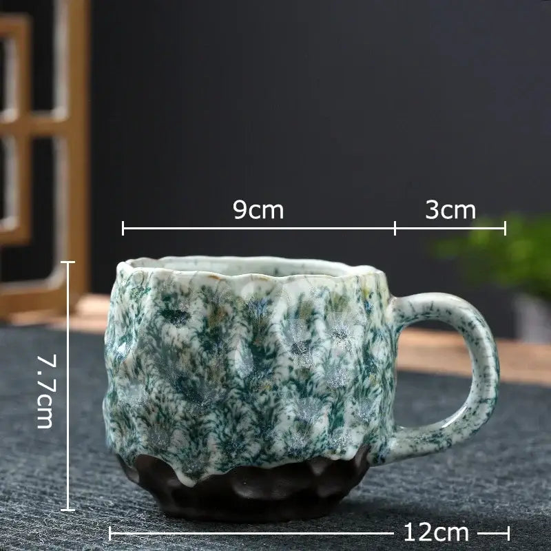 Handcrafted ceramic mug set featuring a green and white speckled glaze with scalloped rim and hammer pattern ceramic design