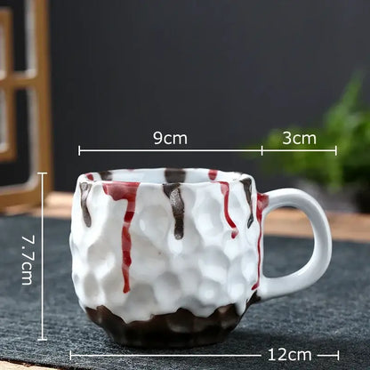 White ceramic hammer pattern ceramic mug with textured hammered surface and red brown decorative drips from ceramic mug set