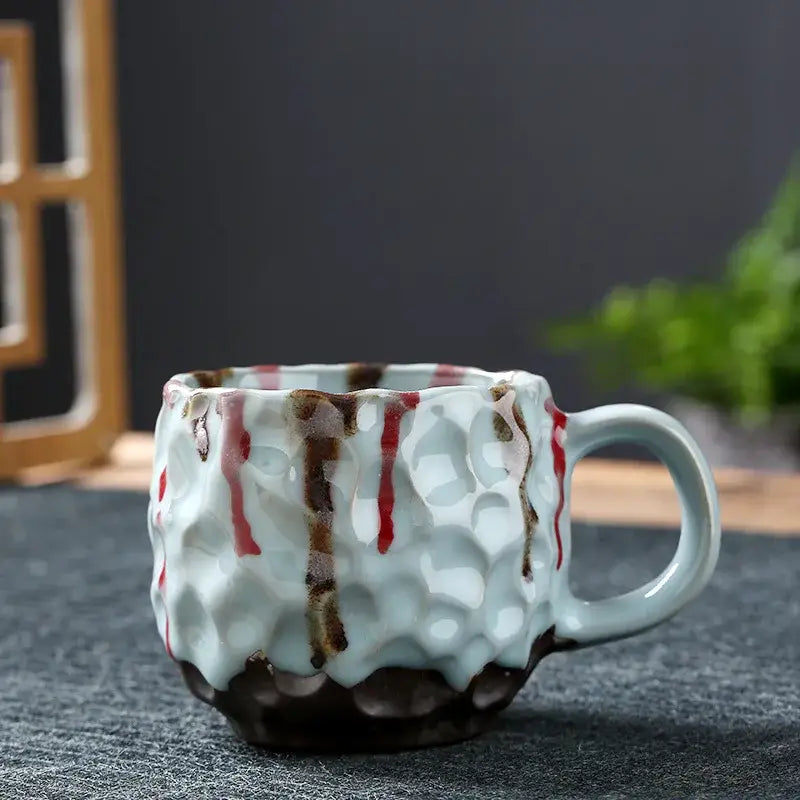 Handcrafted blue and red hammer pattern ceramic mug set featuring a textured honeycomb light blue glaze with brushstrokes