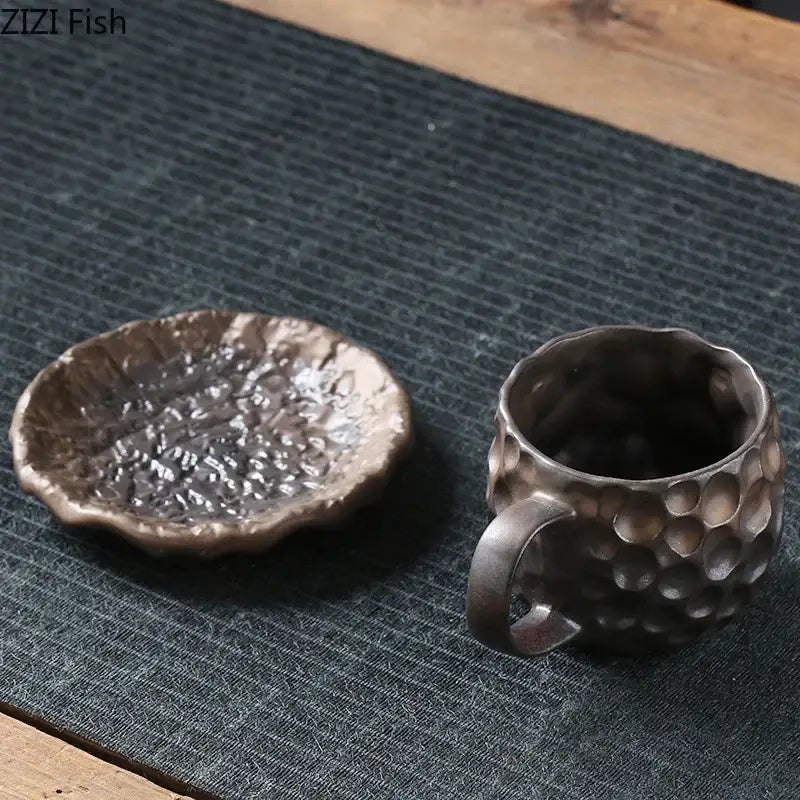 Hand-forged dark metallic mug with hammered texture and saucer featuring rustic artisanal finish ceramic mug set