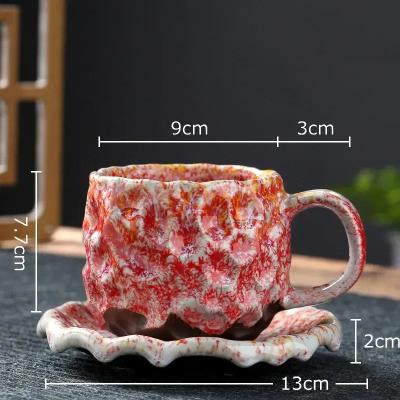Handcrafted red and white marbled hammer pattern ceramic mug set with textured surface and matching saucer for dining room