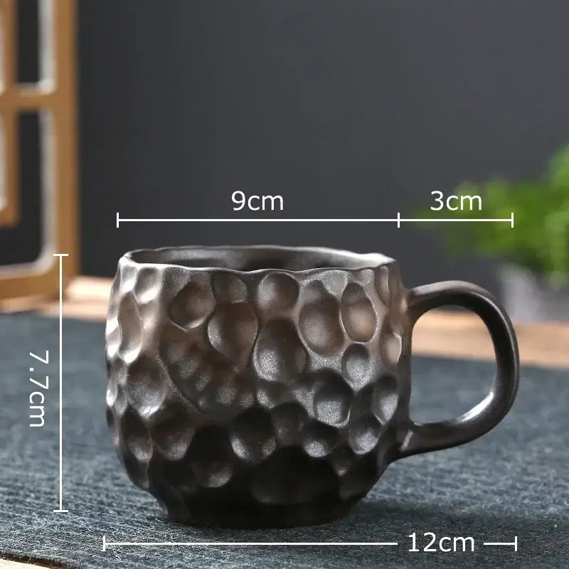 Dark gray hammered textured ceramic mug with rounded handle from handcrafted blue and red hammer pattern ceramic mug set