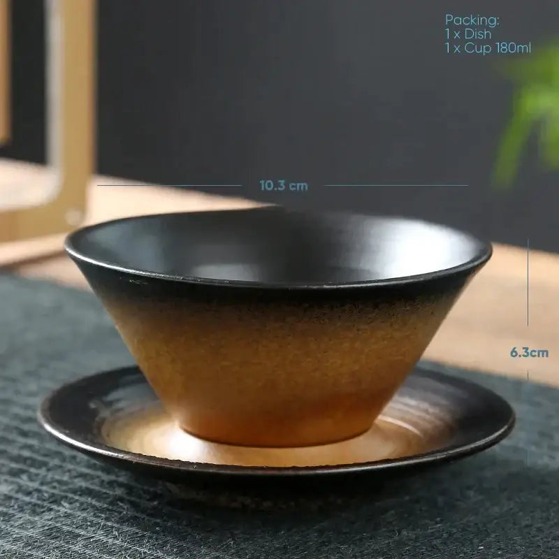 A sleek handcrafted ceramic latte coffee cup and saucer with a brown and amber gradient glaze for dining room use
