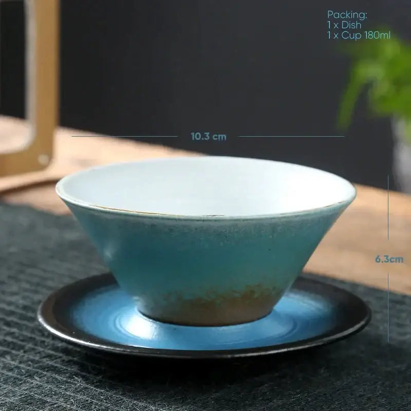 A ceramic latte coffee cup with gradient blue glaze and white interior resting on a matching saucer