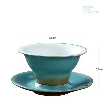 Handcrafted ceramic latte coffee cup and saucer in turquoise with white interior featuring subtle glaze variations