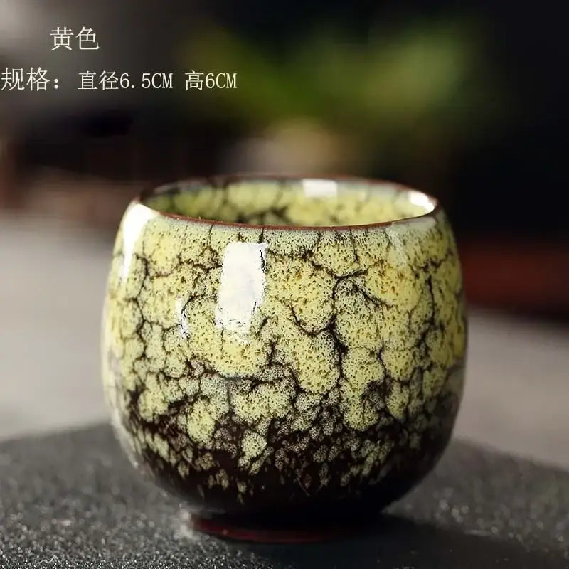Handcrafted egg style ceramic tea cup set with a yellowish-green crackled glaze and dark brown base for dining room use