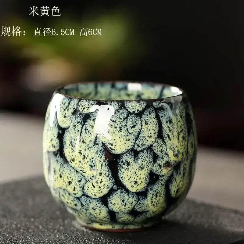 Handcrafted egg style ceramic tea cup with glossy textured glaze in pale yellow and dark green for dining room use