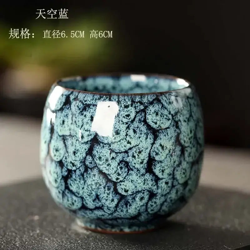 Handcrafted egg style ceramic tea cup with textured sky blue and black crackled glaze for dining room use