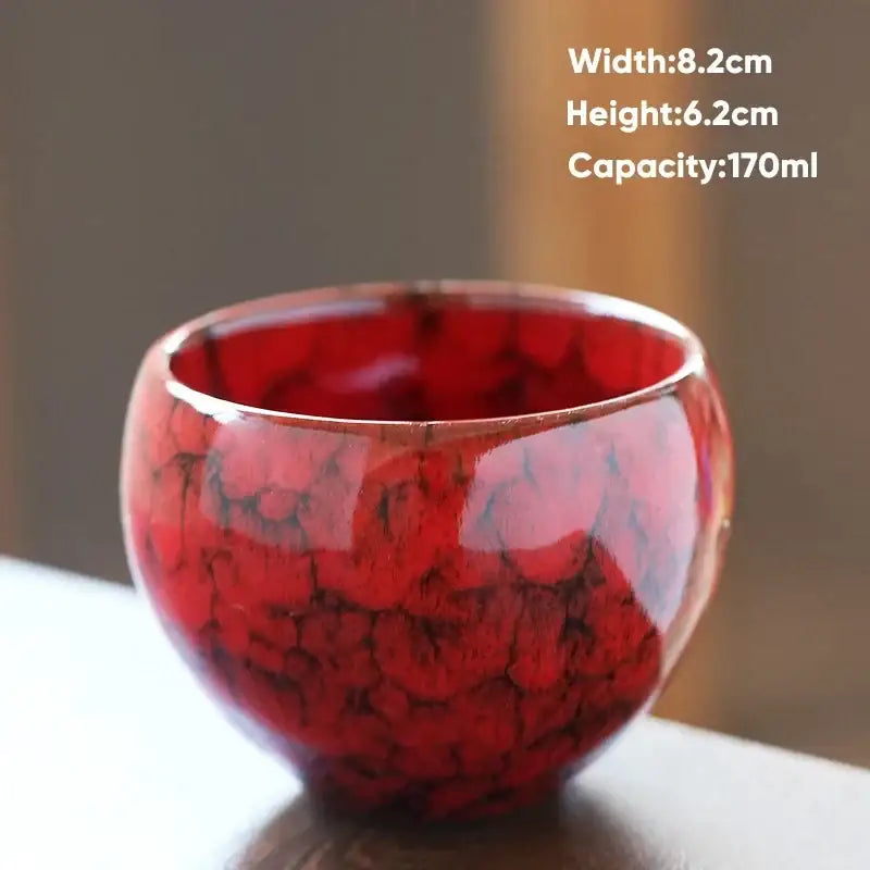 A glossy red handcrafted ceramic coffee cup with distinctive crackled glaze perfect for dining room drinkware