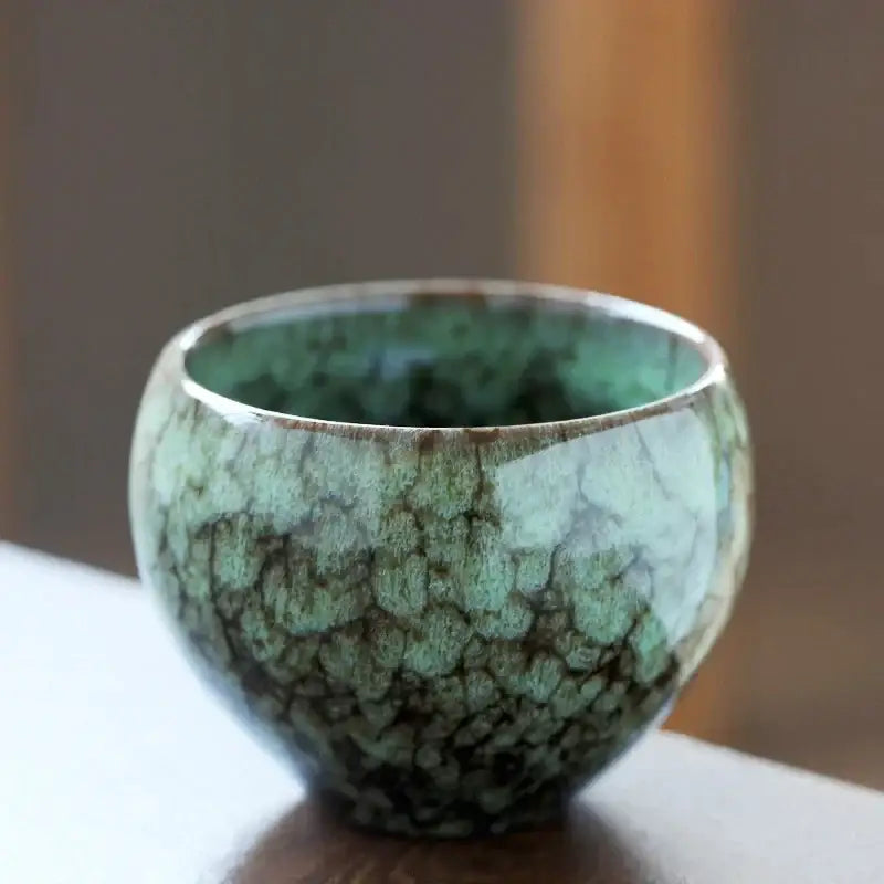 Handcrafted crackle glaze ceramic coffee cup with green and brown textured surface for dining room drinkware