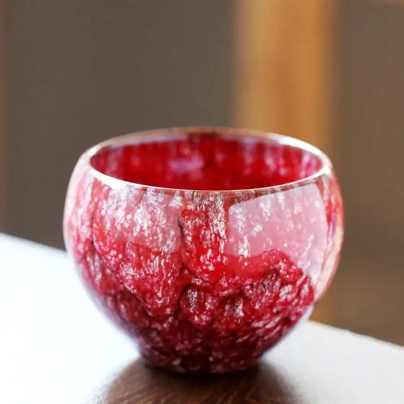Vibrant red handcrafted ceramic coffee cup with a textured crackle glaze finish for dining room drinkware