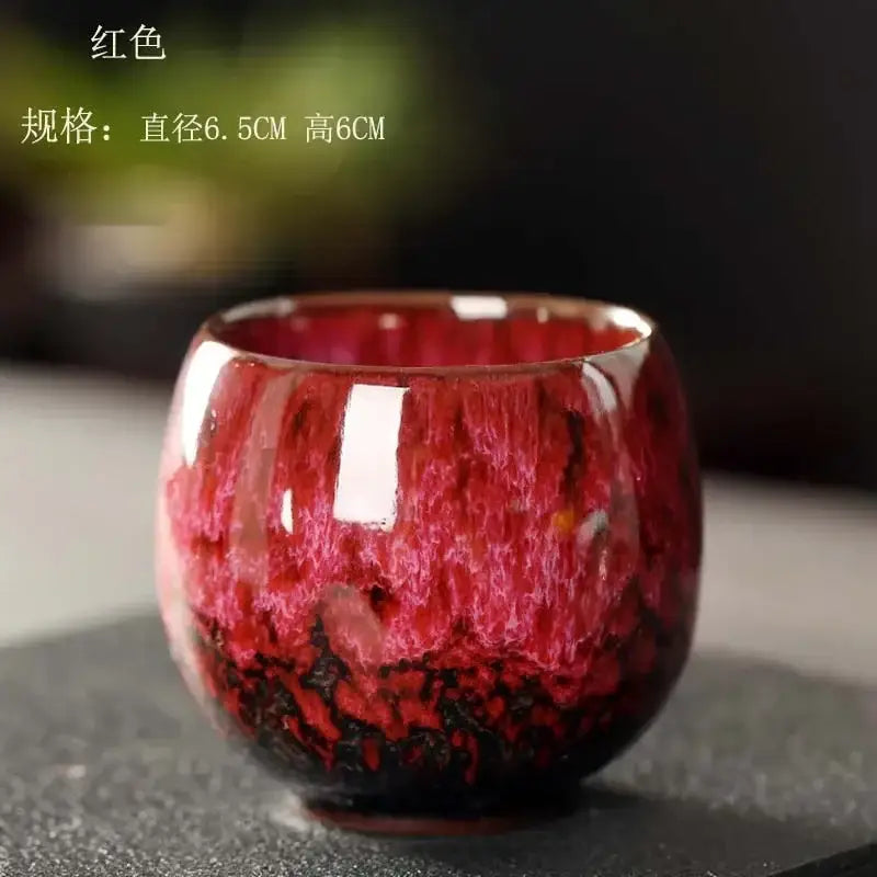 A glossy red ceramic kung fu tea cup set featuring a handcrafted crackle glaze with deep crimson and black swirls