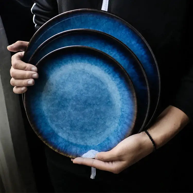 Set of three handcrafted ceramic round plates with gradient blue glaze and dark brown rim for dining room use