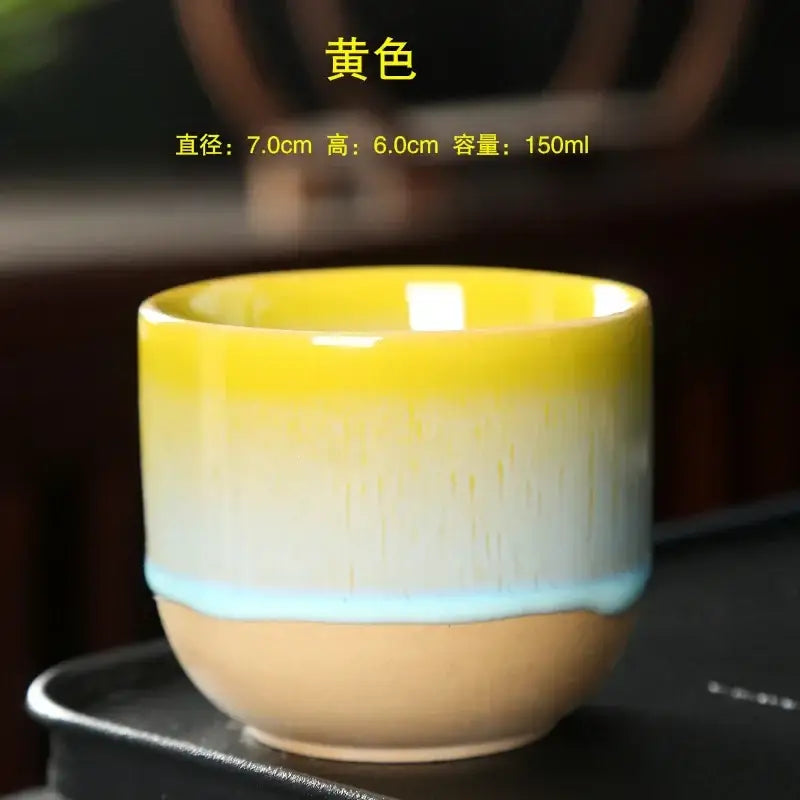 Handcrafted ceramic kung fu tea cup with gradient yellow to blue glaze resting on dark surface for dining room decorbites ceramic kung use