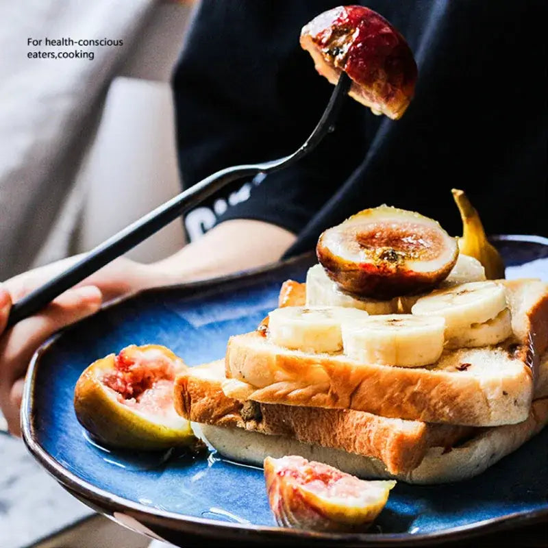 A handcrafted gradient deep blue ceramic dessert plate from decorbites holding toasted bread with banana and figs
