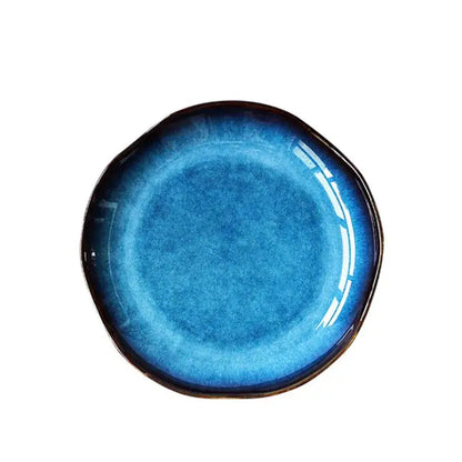 Glossy handcrafted ceramic dessert plate with deep blue gradient glaze darkening to black rim decorbites deep blue set