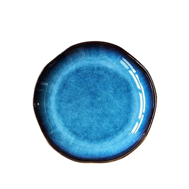 Glossy handcrafted ceramic dessert plate with deep blue gradient glaze darkening to black rim decorbites deep blue set