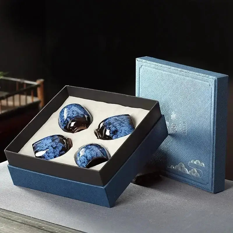 Set of four handcrafted glossy blue decorbites ceramic cups with speckled glaze in navy gift box ceramic cups set