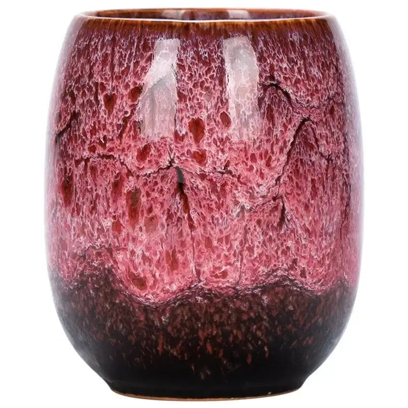 Handcrafted multicolored ceramic tea cup with glossy crackled glaze in burgundy pink and reddish hues for drinkware set