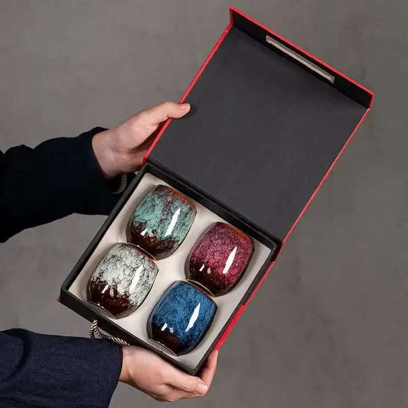 Handcrafted multicolored ceramic tea cup set with vibrant teal burgundy blue and gray swirling glazes for dining use