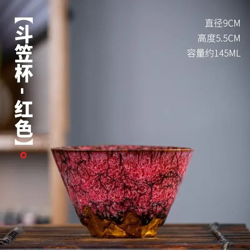 A vibrant red ceramic tea cup with crackled glaze and golden base from a handcrafted multicolored cup set