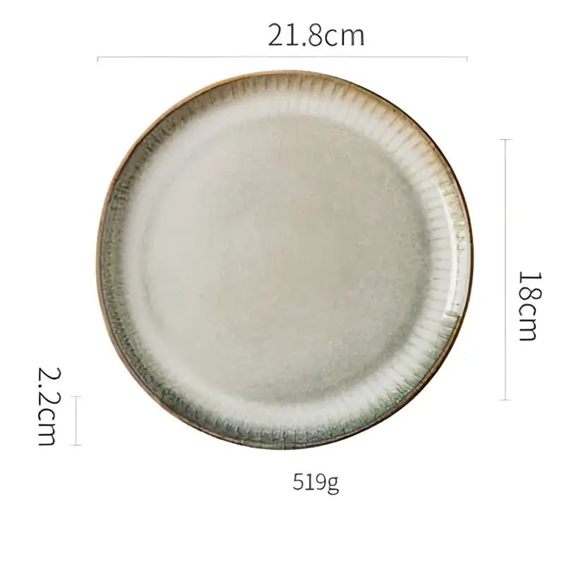 A handcrafted decorbites ceramic dessert plate with a subtle speckled gray glaze and textured raised ridge rim