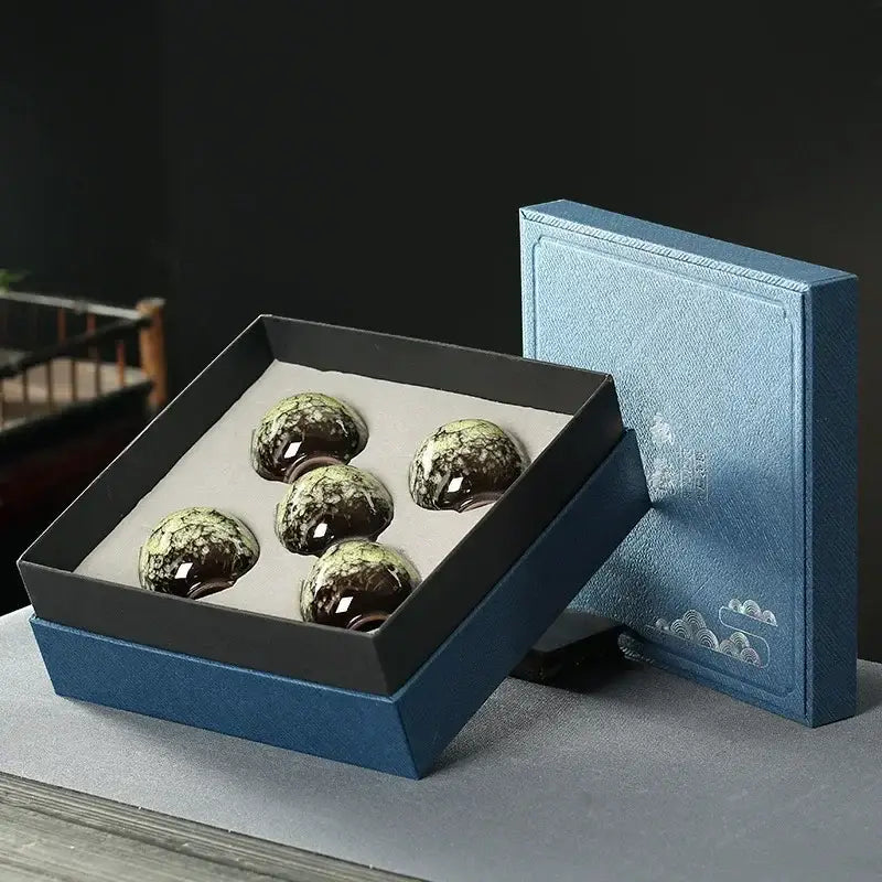 Five glossy dark green and white marbled decorbites ceramic cups set in black-lined blue gift box for dining room decor