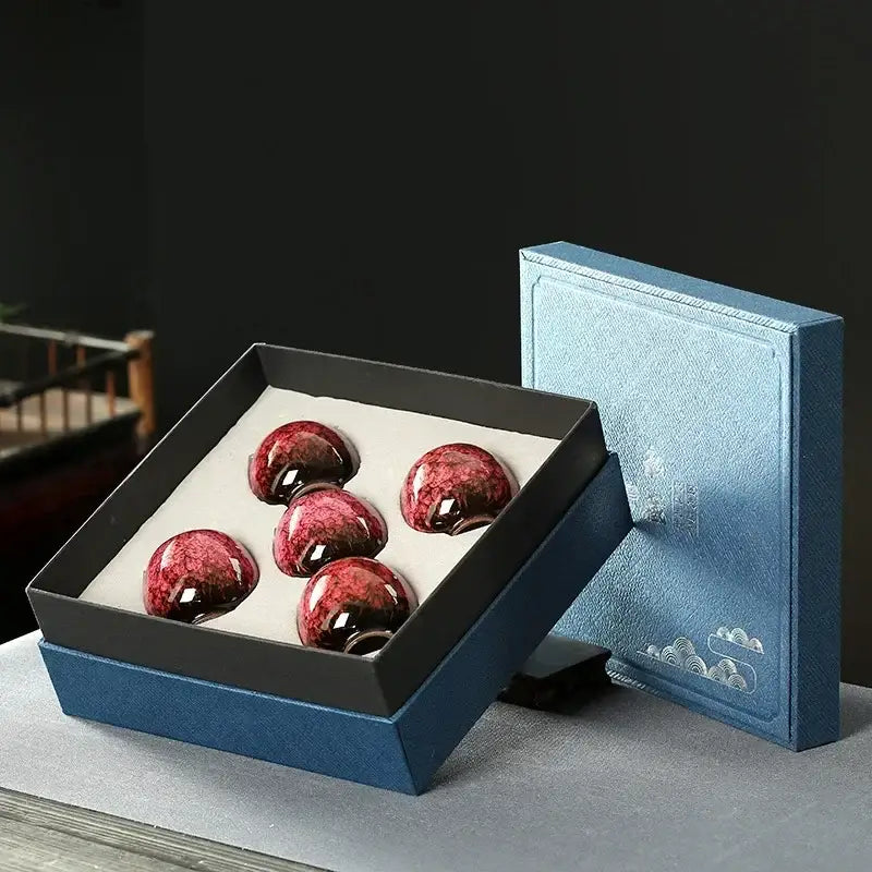 Five glossy crimson handcrafted decorbites ceramic cups set with marbled finish in a black-lined blue gift box