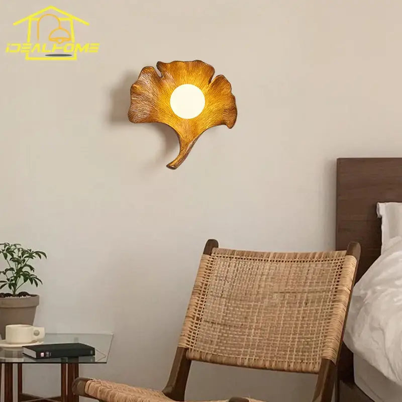 Handcrafted wooden ginkgo biloba resin wall lamp with warm-toned textured finish and central circular light for bedroom decorbites ginkgo biloba