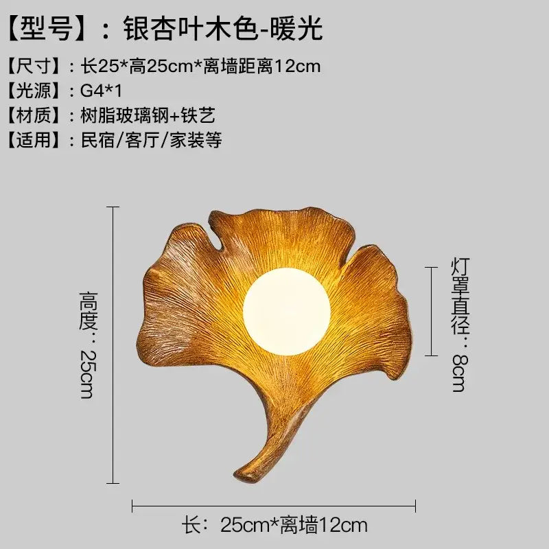A warm golden wall lamp resembling a ginkgo biloba leaf made of resin glass steel and iron art by decorbites