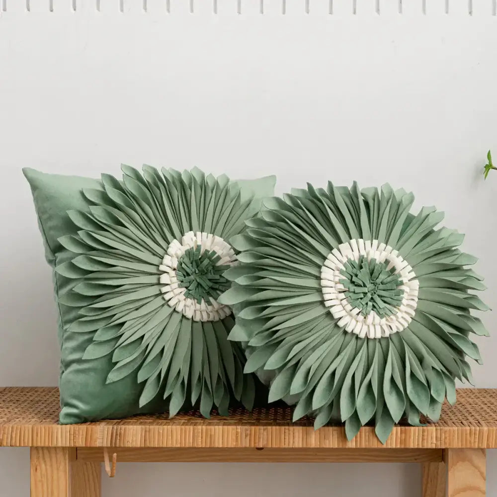 Two sage green velvet cushion covers with decorbites 3d chrysanthemum flower design featuring layered petals and white centers