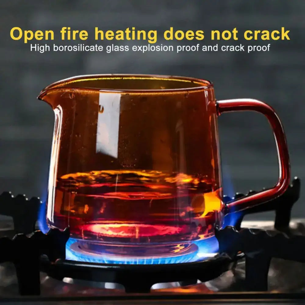 Amber-colored high borosilicate glass coffee sharing pot with red handle designed for safe open-fire heating