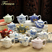 A collection of decorbites ceramic kung fu teapots featuring colorful designs with dragon motifs and silver-leaf detailing