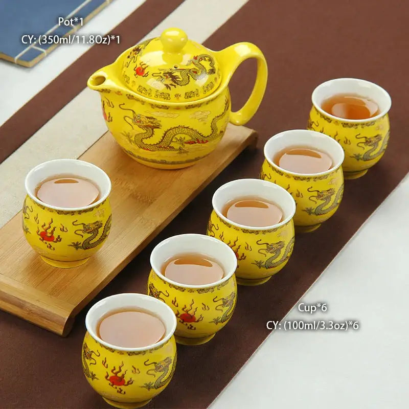 Vibrant yellow handmade ceramic kung fu teapot with golden dragon motifs and six cups on wooden tray by decorbites ceramic