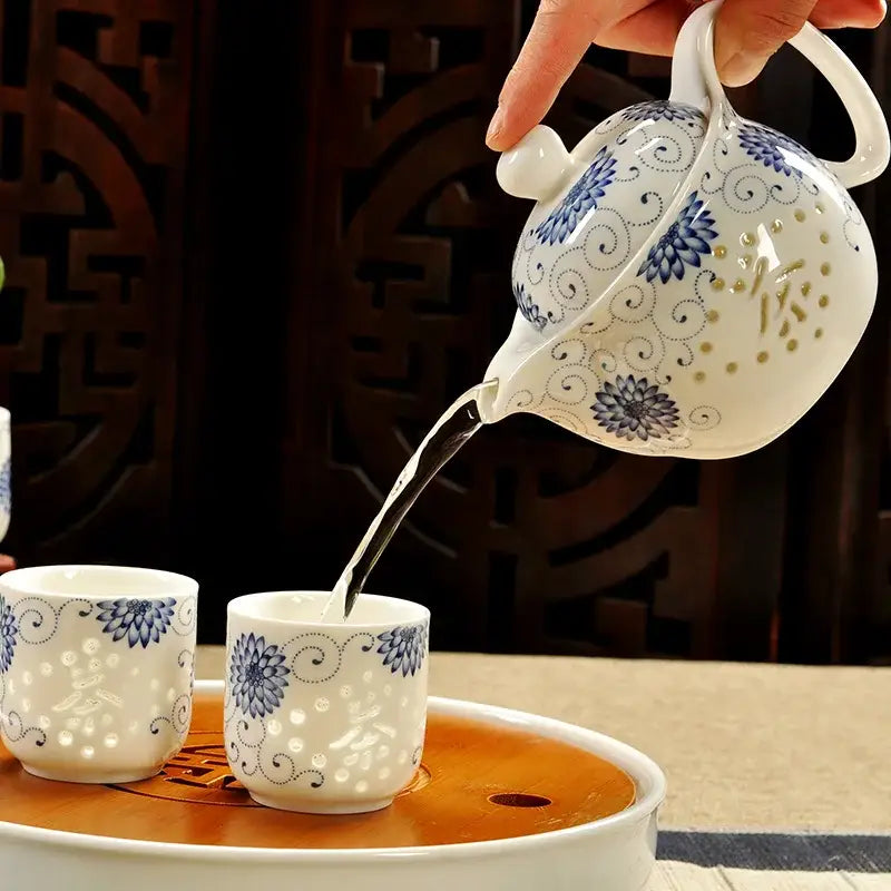 Handmade white ceramic kung fu teapot with intricate blue floral patterns and gold dots by decorbites ceramic kung