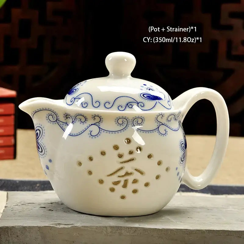 Handmade decorbites ceramic kung fu teapot in white with blue patterns and gold perforations forming chinese tea character