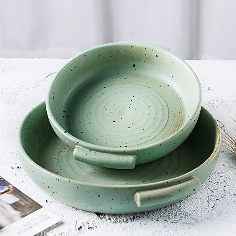 Set of two handmade ceramic sushi bowls in sage green with speckled glaze and integrated handles for dining use